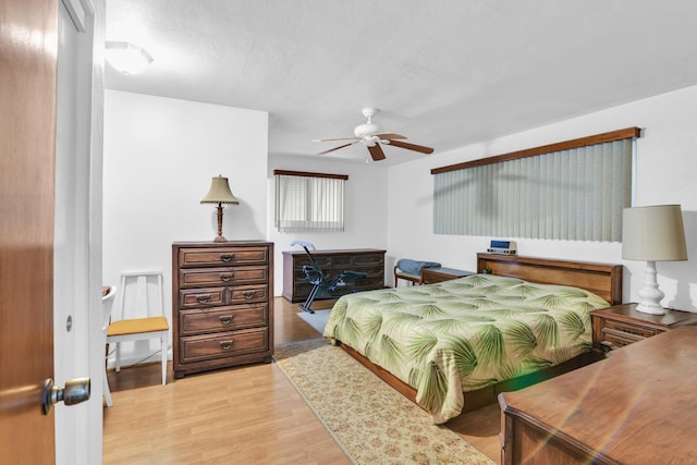 bedroom with light hardwood / wood-style flooring and ceiling fan