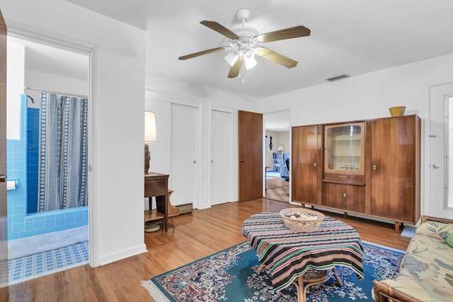 living room with ceiling fan and wood-type flooring