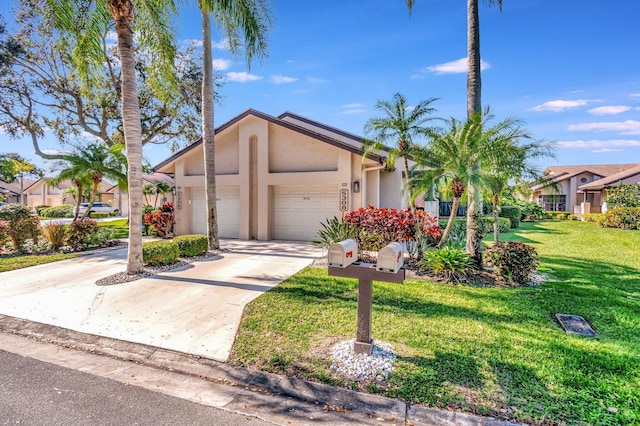 view of front of house with a garage and a front lawn