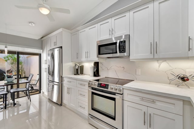 kitchen featuring stainless steel appliances, tasteful backsplash, white cabinets, and light stone counters