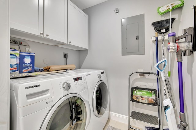 laundry room featuring independent washer and dryer, cabinets, and electric panel