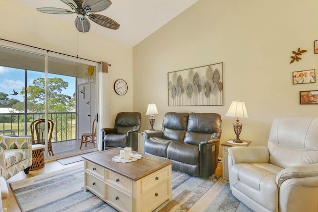 living room featuring vaulted ceiling, ceiling fan, and light hardwood / wood-style flooring