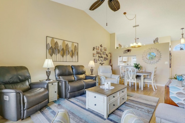 living room with lofted ceiling, light hardwood / wood-style floors, and ceiling fan