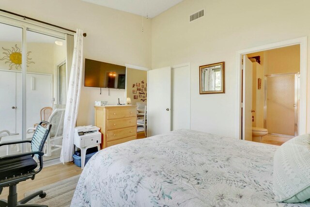 bedroom featuring ceiling fan, lofted ceiling, light wood-type flooring, and access to outside