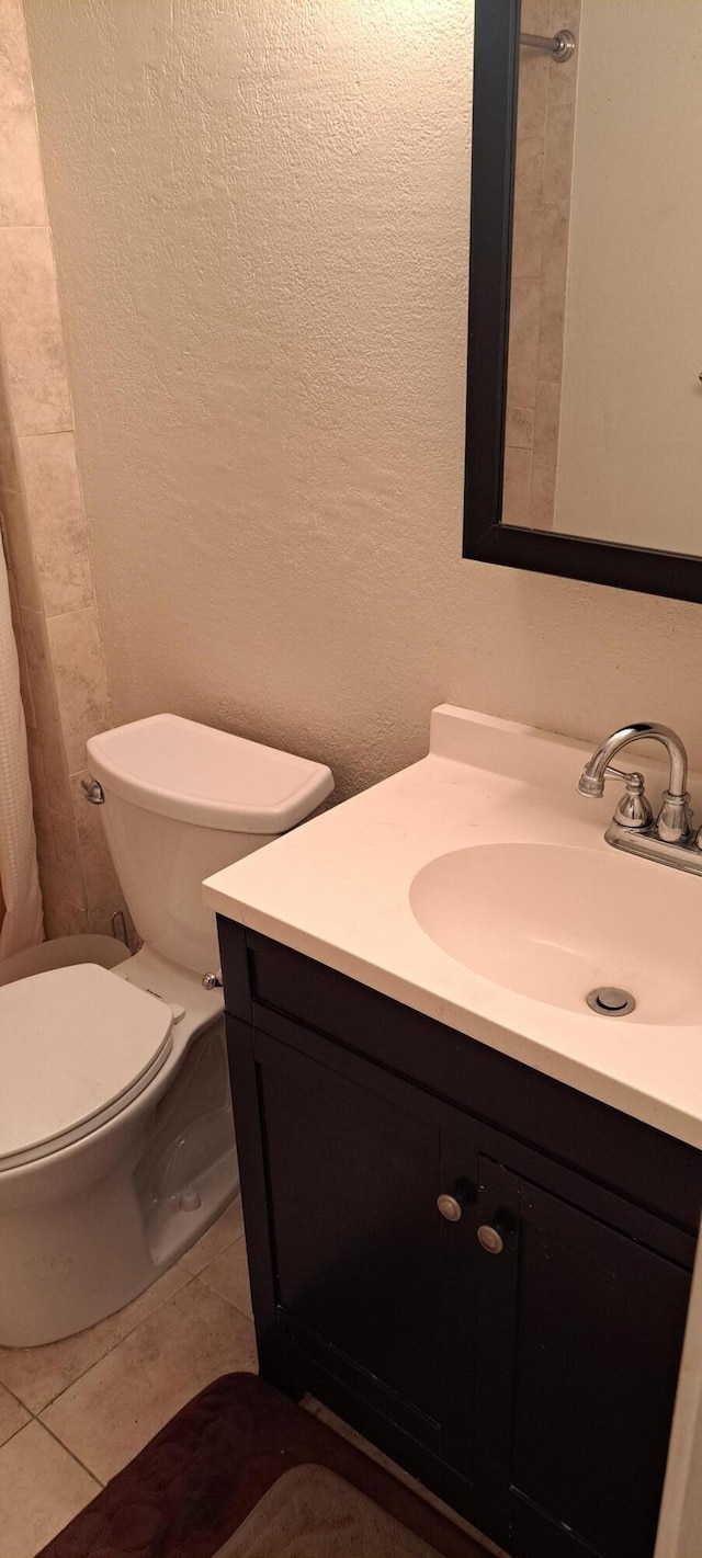 bathroom with tile patterned floors, toilet, and vanity