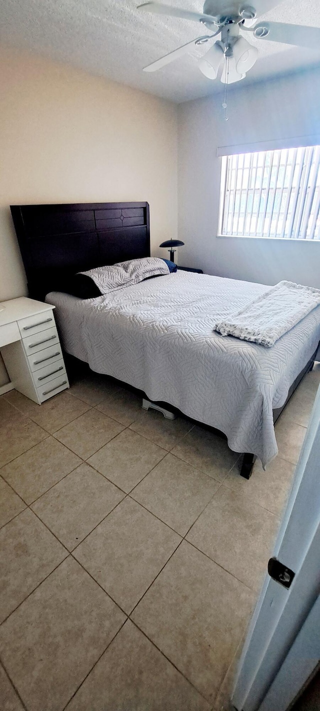 tiled bedroom with ceiling fan