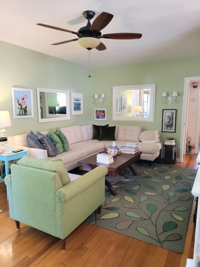 living room featuring ceiling fan and hardwood / wood-style floors