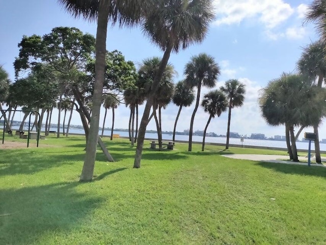 surrounding community featuring a yard and a water view