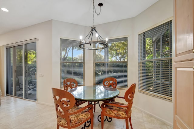 tiled dining area featuring a notable chandelier and a wealth of natural light