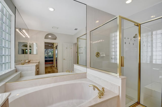 bathroom featuring independent shower and bath and vanity