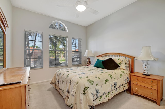 bedroom featuring light colored carpet and ceiling fan