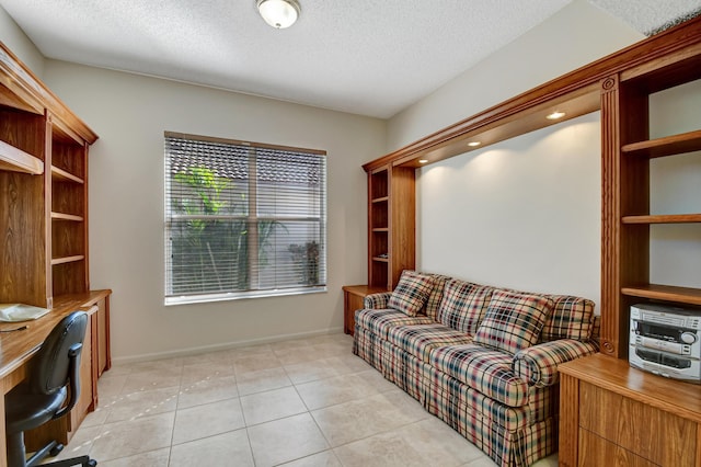 interior space with light tile patterned flooring and a textured ceiling