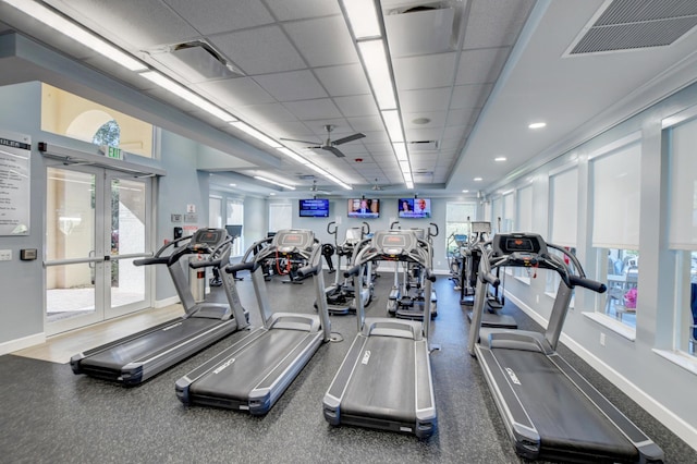 exercise room with a drop ceiling and french doors