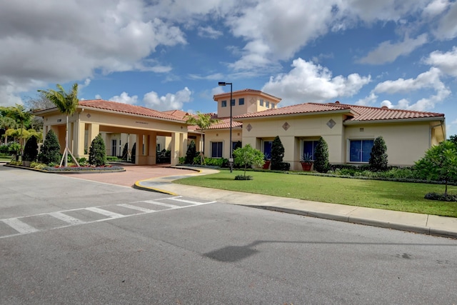 mediterranean / spanish house with a front yard