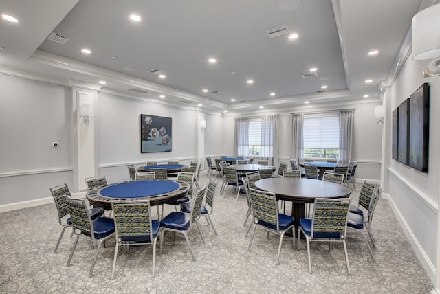 dining space featuring crown molding and a raised ceiling