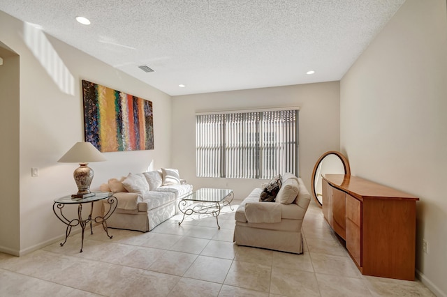 living room featuring light tile patterned floors and a textured ceiling