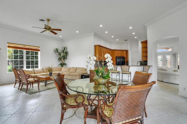 dining area featuring arched walkways, crown molding, recessed lighting, visible vents, and a ceiling fan