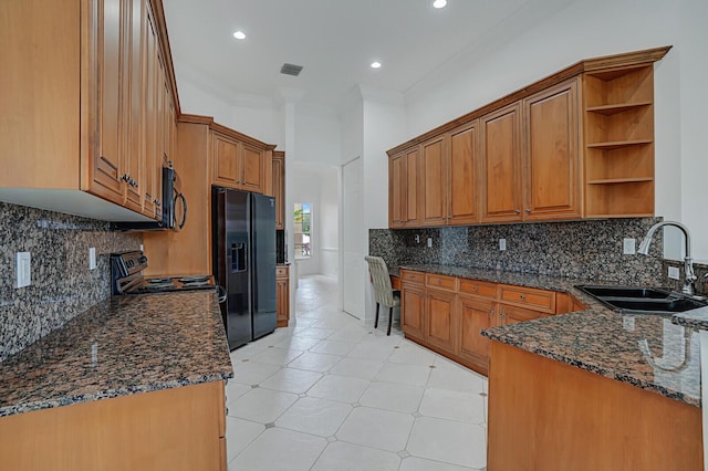 kitchen with visible vents, dark stone countertops, black appliances, open shelves, and a sink