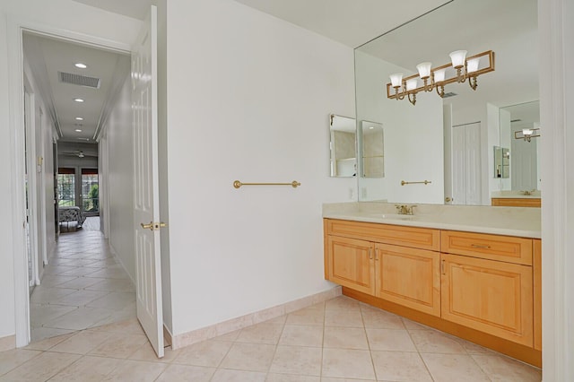 bathroom with tile patterned flooring, visible vents, baseboards, and vanity