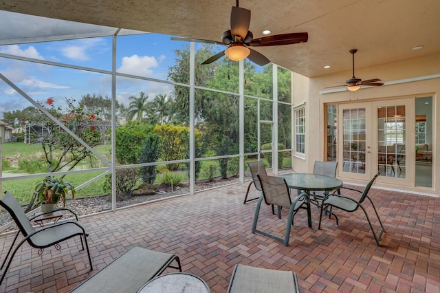 unfurnished sunroom featuring a ceiling fan