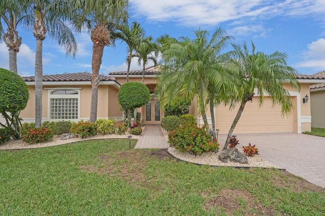 view of front of house featuring a front lawn, decorative driveway, and stucco siding