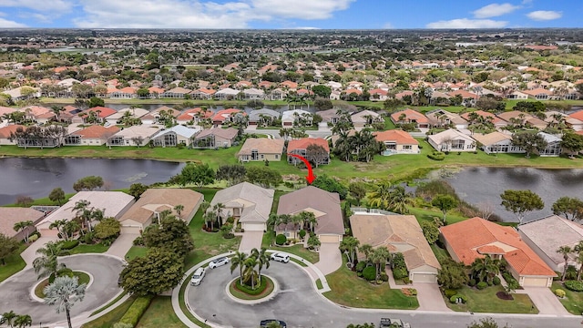 drone / aerial view featuring a water view and a residential view