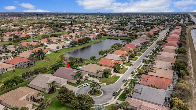 drone / aerial view with a water view and a residential view