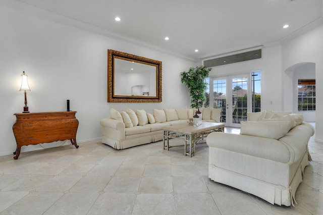 living area with arched walkways, recessed lighting, baseboards, and crown molding