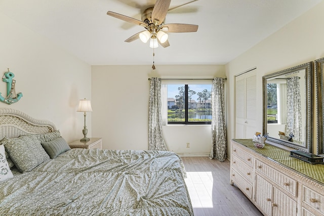 bedroom with ceiling fan and light hardwood / wood-style flooring