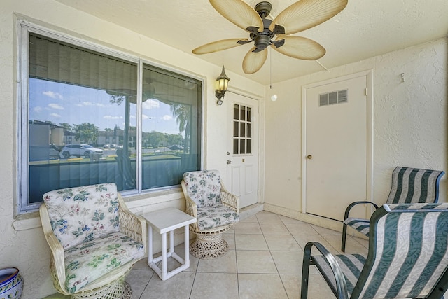 sunroom / solarium featuring ceiling fan