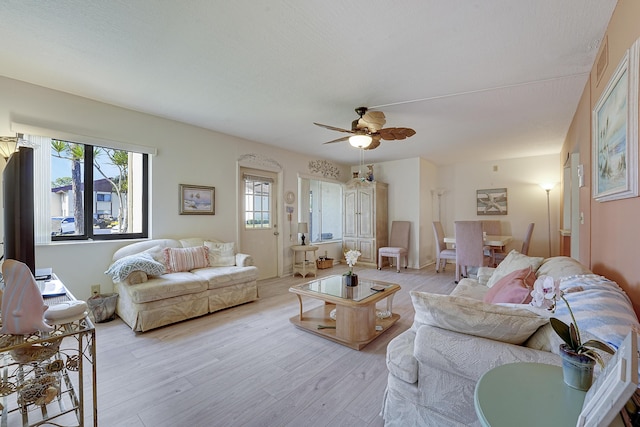 living room with ceiling fan and light hardwood / wood-style floors