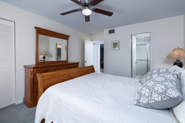 carpeted bedroom featuring ceiling fan and a textured ceiling