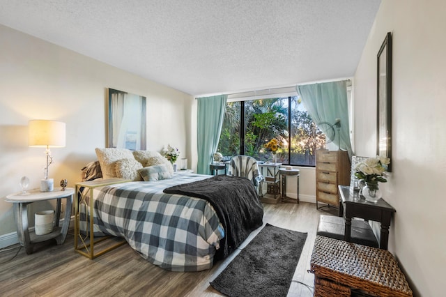 bedroom featuring hardwood / wood-style floors and a textured ceiling