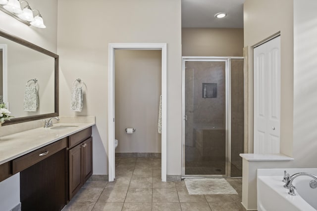 full bathroom with tile patterned floors, vanity, toilet, and independent shower and bath