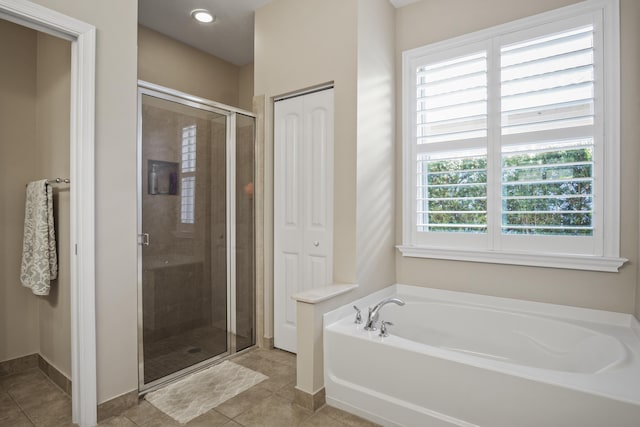 bathroom featuring shower with separate bathtub and tile patterned flooring