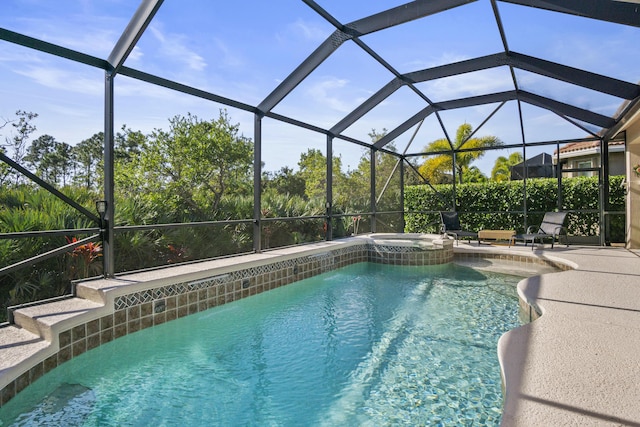 view of pool with an in ground hot tub, a patio, and glass enclosure