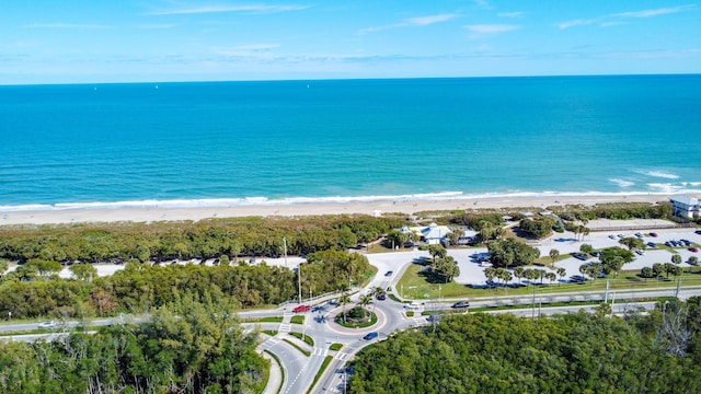 birds eye view of property featuring a water view and a view of the beach