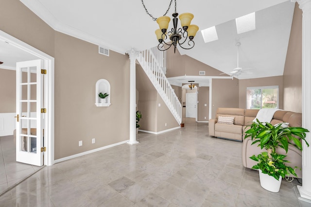 unfurnished living room featuring lofted ceiling, ceiling fan with notable chandelier, ornamental molding, and decorative columns