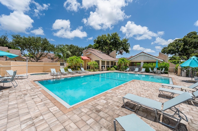 view of pool featuring a gazebo, a community hot tub, and a patio