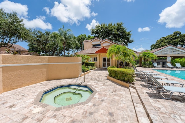 view of swimming pool with a patio area and a community hot tub