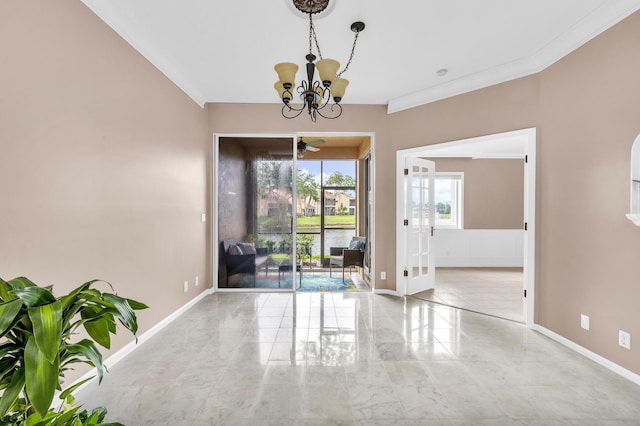 empty room with crown molding, a chandelier, and french doors