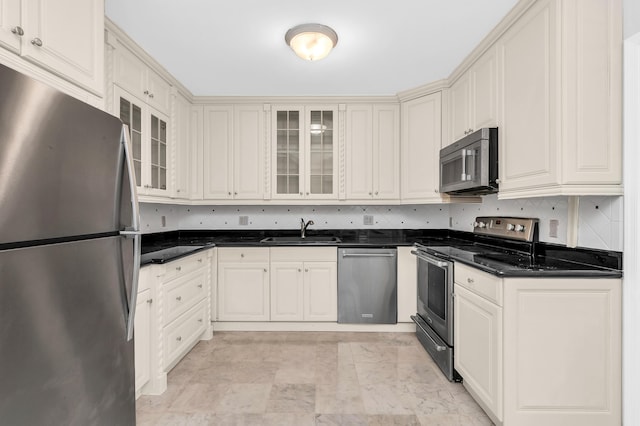 kitchen featuring appliances with stainless steel finishes, sink, and backsplash