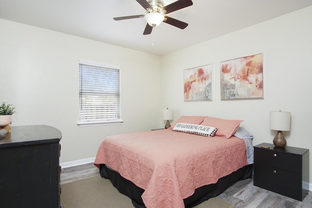 bedroom with ceiling fan and light hardwood / wood-style floors