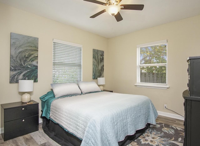 bedroom with light hardwood / wood-style floors and ceiling fan