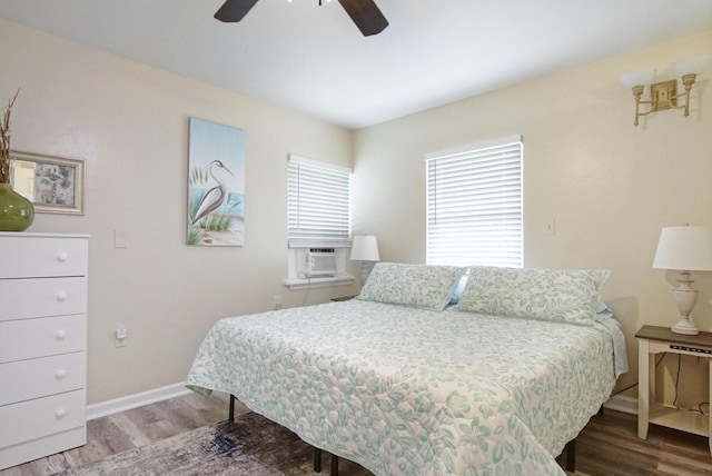 bedroom with cooling unit, hardwood / wood-style flooring, and ceiling fan