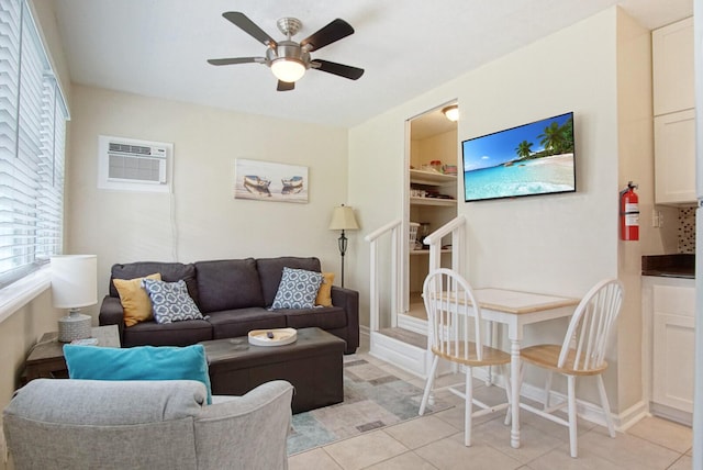 living room with light tile patterned flooring, a wall mounted air conditioner, and ceiling fan