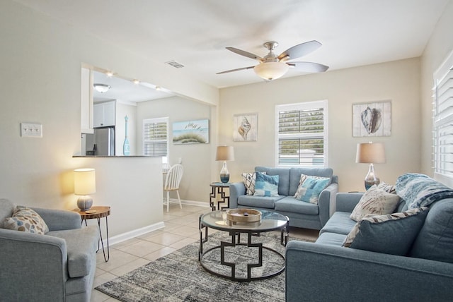 tiled living room featuring ceiling fan