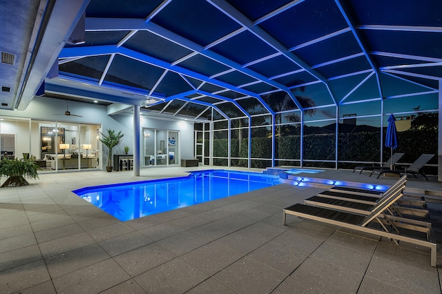 view of pool featuring an in ground hot tub, a patio, ceiling fan, and glass enclosure