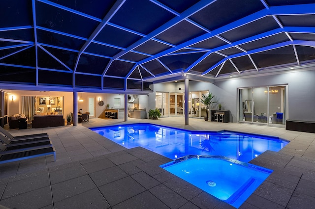 view of swimming pool featuring an in ground hot tub, a lanai, and a patio area