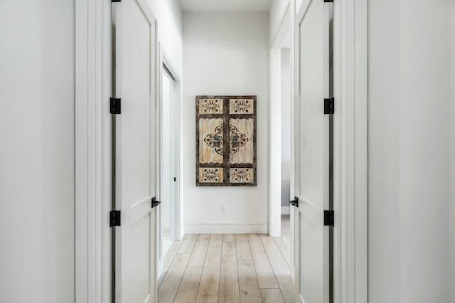 corridor with light hardwood / wood-style flooring